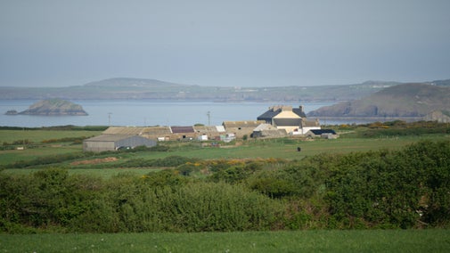 Southwood estate farm building with Pembrokeshire coastline in the distance